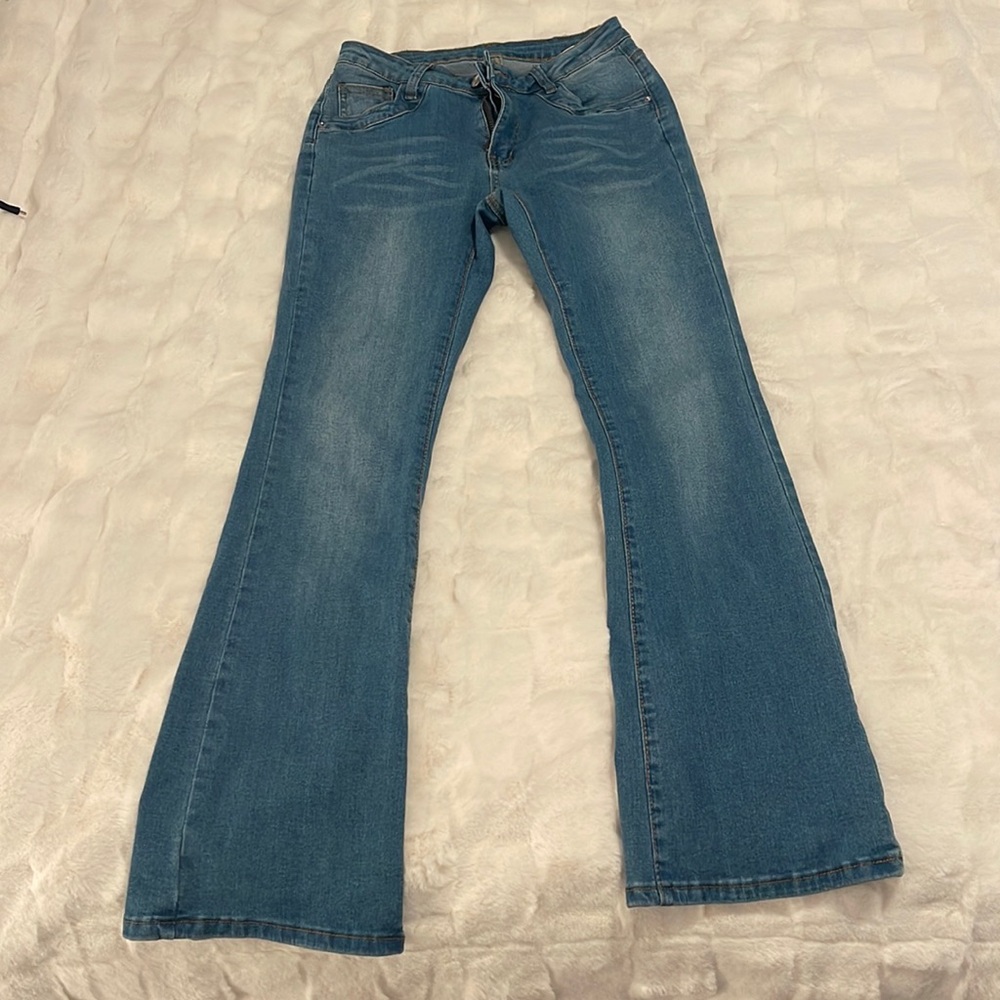 Never worn, low rise blue jeans, size 4
